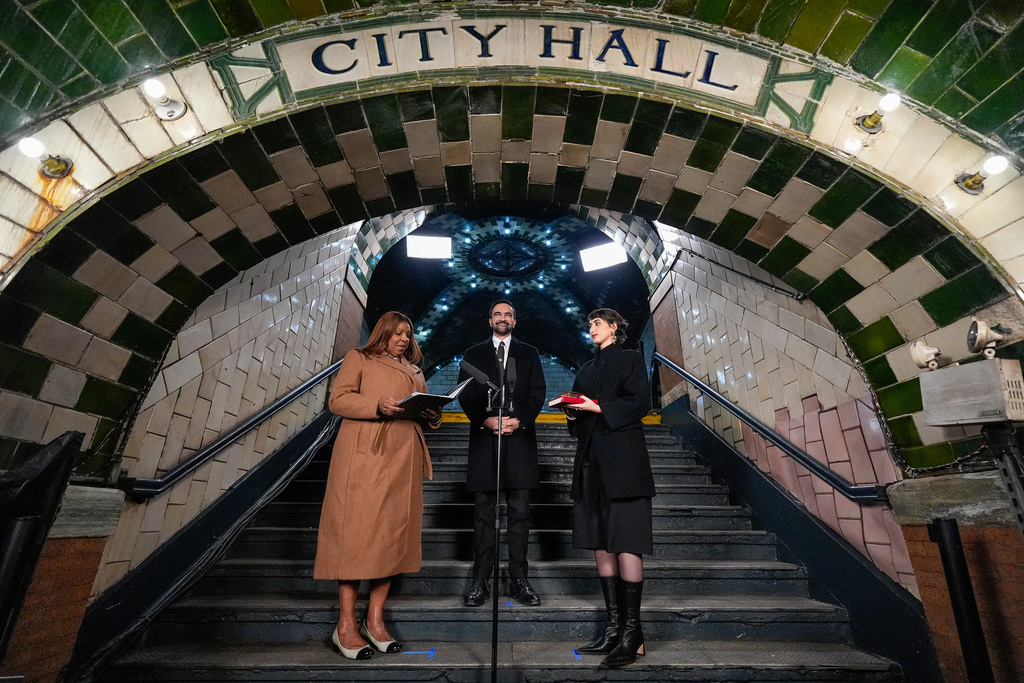 New York Attorney General Letitia James, left, administers the oath of office to mayor-elect Zohran Mamdani, center, as his wife Rama Duwaji looks on, Thursday, Jan. 1, 2026, in New York. (AP Photo/Yuki Iwamura)