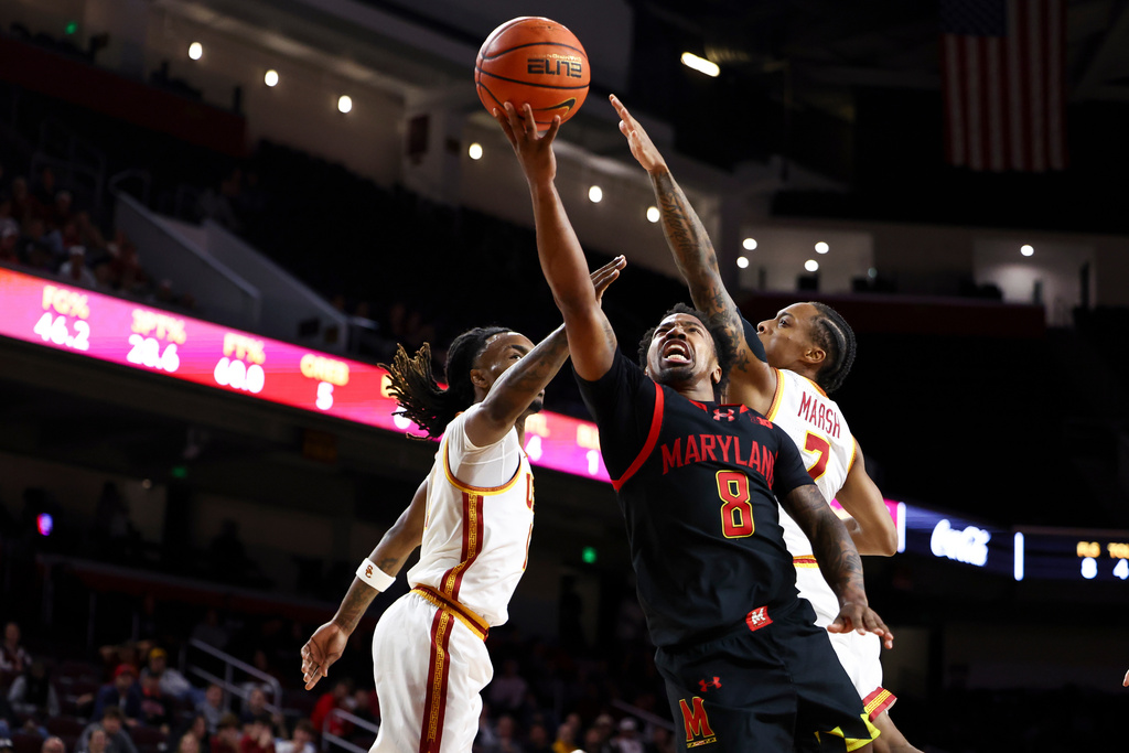 Maryland guard David Coit (8) drives to the basket against Southern California guard Kam Woods, left, and guard Jordan Marsh, right, during the first half of an NCAA college basketball game, Tuesday, Jan. 13, 2026, in Los Angeles. (AP Photo/Jessie Alcheh)