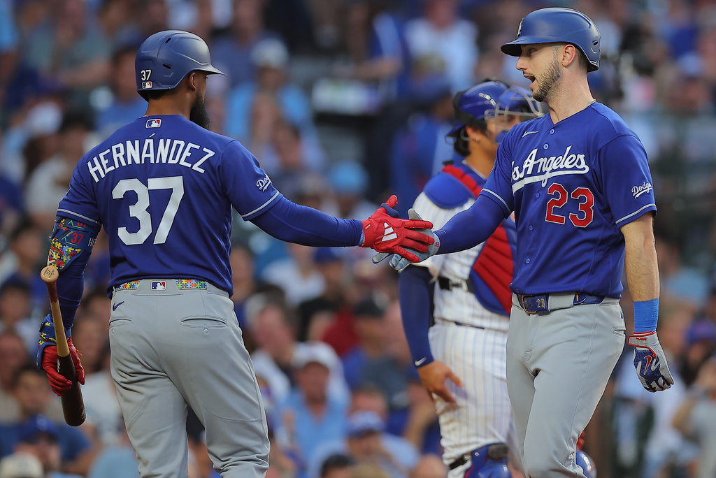 Los Angeles Dodgers' Kyle Tucker, right, celebrates with teammate Teoscar Hernández after hitting a home run during the second inning of a baseball game against the Chicago Cubs, Tuesday, Aug. 4, 2026, in Chicago. (AP Photo/Melissa Tamez)