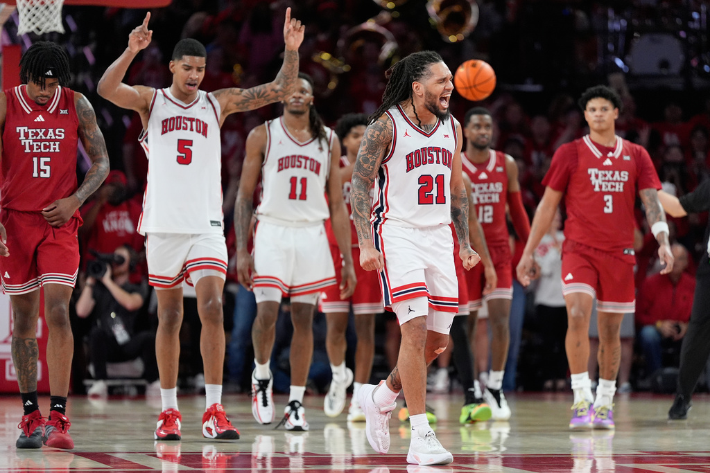 Houston guard Emanuel Sharp (21) and center Chris Cenac Jr. (5) celebrate after a foul call during the second half of an NCAA college basketball game against Texas Tech in Houston, Tuesday, Jan. 6, 2026. (AP Photo/Ashley Landis)