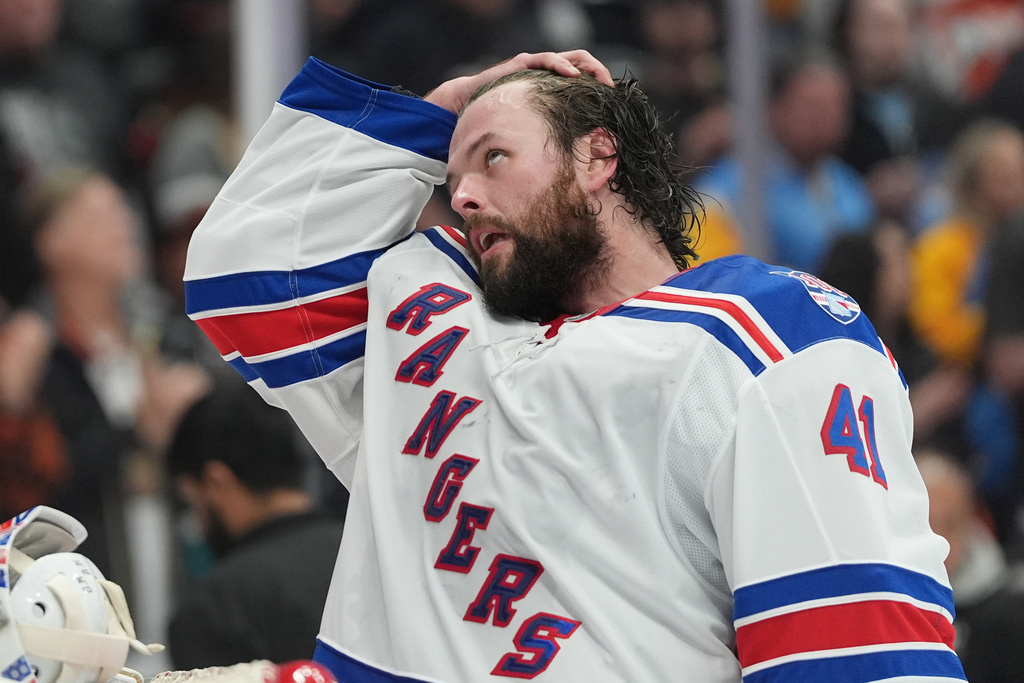 New York Rangers goaltender Spencer Martin takes off his helmet during a break in the first period of an NHL hockey game against the Anaheim Ducks Monday, Jan. 19, 2026, in Anaheim, Calif. (AP Photo/Gregory Bull)