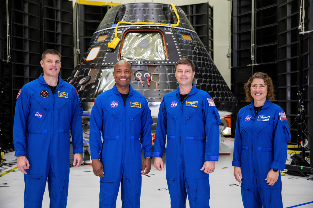 FILE - In this photo provided by NASA, Artemis II crew members, from left, Jeremy Hansen, Victor Glover, Reid Wiseman and Christina Koch, stand together at NASA's Kennedy Space Center in Florida, in front of an Orion crew module on Tuesday, Aug. 8, 2023. (Kim Shiflett/NASA via AP, File)