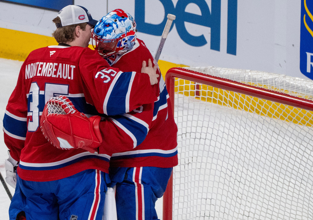 Montreal Canadiens goaltender Jakub Dobes, right, is congratulated on a win over the Colorado Avalanche by fellow goaltender Samuel Montembeault (35) after NHL hockey game action in Montreal, Thursday, Jan. 29, 2026. (Christinne Muschi/The Canadian Press via AP)