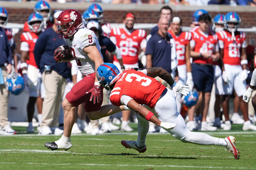 Washington State running back Kirby Vorhees (9) runs past Mississippi safety Sage Ryan (3) on his way to a 46-yard touchdown run during the second half of an NCAA college football game, Saturday, Oct. 11, 2025, in Oxford, Miss. (AP Photo/Rogelio V. Solis)