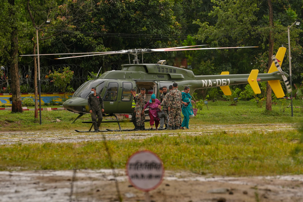 Survivors rescued from flash flooding are brought to safer place by army helicopters in Nuwakot district in Nepal, Saturday, Aug. 29, 2026. (AP Photo/Dar Yasin)