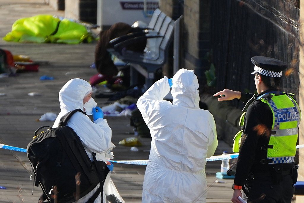 Forensic investigators look at the area where travellers left their belongings after a mass stabbing on a London-bound train in Huntingdon, England, Sunday, Nov. 2, 2025.(AP Photo/Kirsty Wigglesworth)