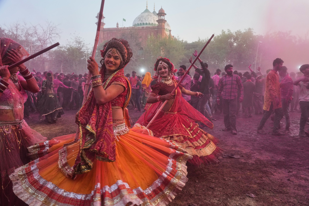 Members of transgender community dance during Holi festival celebrations at the Shri Krishna Janmabhoomi Temple complex in Mathura, India, on Feb. 27, 2026. (AP Photo/Manish Swarup)