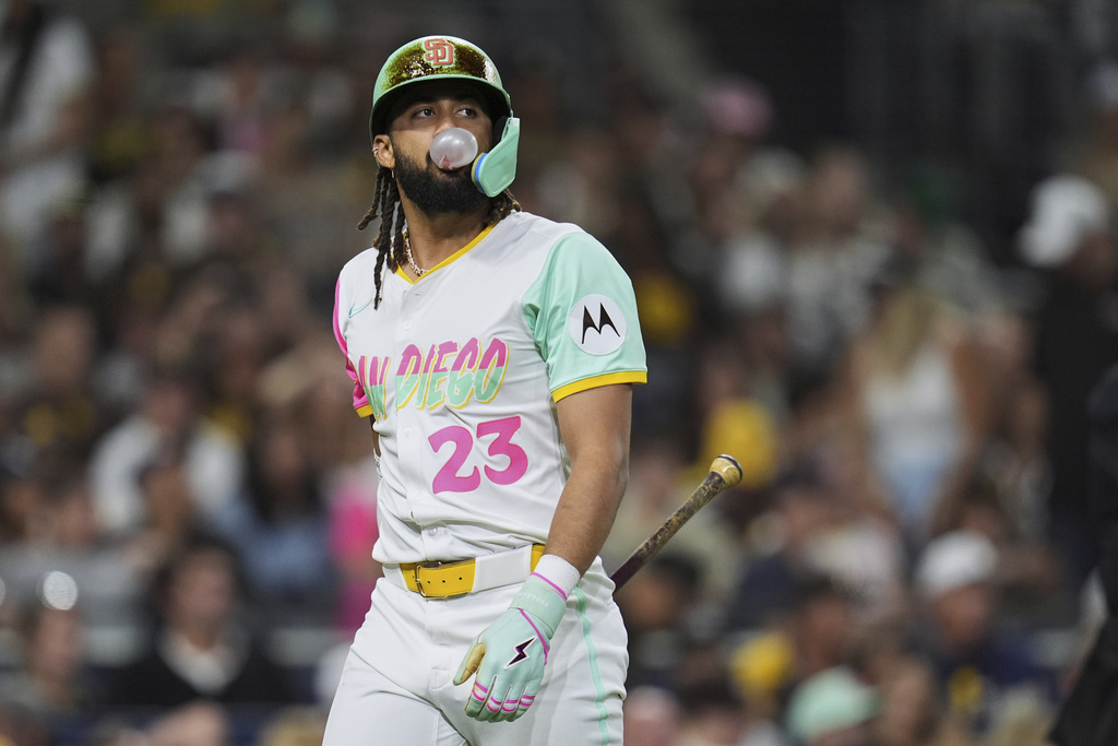 San Diego Padres' Fernando Tatis Jr. blows a bubble after striking out to end the eighth inning of a baseball game against the Colorado Rockies Friday, Sept. 12, 2025, in San Diego. (AP Photo/Gregory Bull)