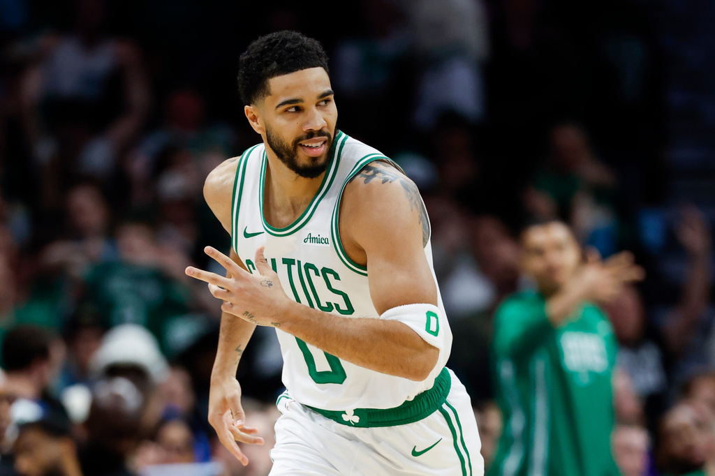 Boston Celtics forward Jayson Tatum reacts after making a 3-point basket against the Charlotte Hornets during the first half of an NBA basketball game in Charlotte, N.C., Sunday, March 29, 2026. (AP Photo/Nell Redmond)