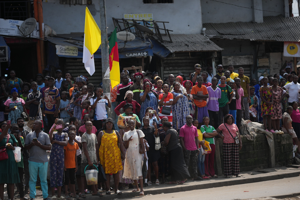 People wait for Pope Leo XIV in Douala, Cameroon, Friday, April 17, 2026 on the fifth day of his 11-day pastoral visit to Africa. (AP Photo/Andrew Medichini)
