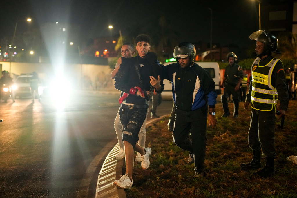 A boy is detained as youth led protests calling for healthcare and education reforms turned violent, in Sale, Morocco, Wednesday, Oct. 1, 2025. (AP Photo/Mosa'ab Elshamy)
