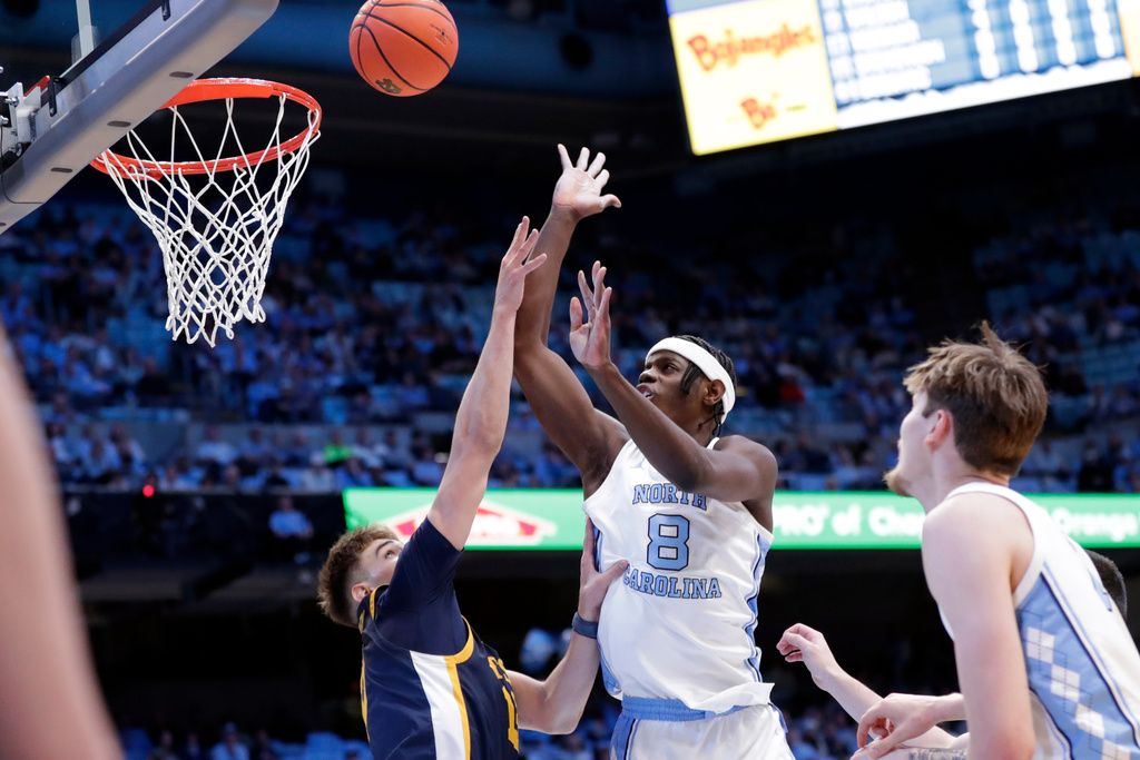 North Carolina forward Caleb Wilson (8) shoots against East Tennessee State forward Blake Barkley, left, during the first half of an NCAA college basketball game Tuesday, Dec. 16, 2025, in Chapel Hill, N.C. (AP Photo/Chris Seward)