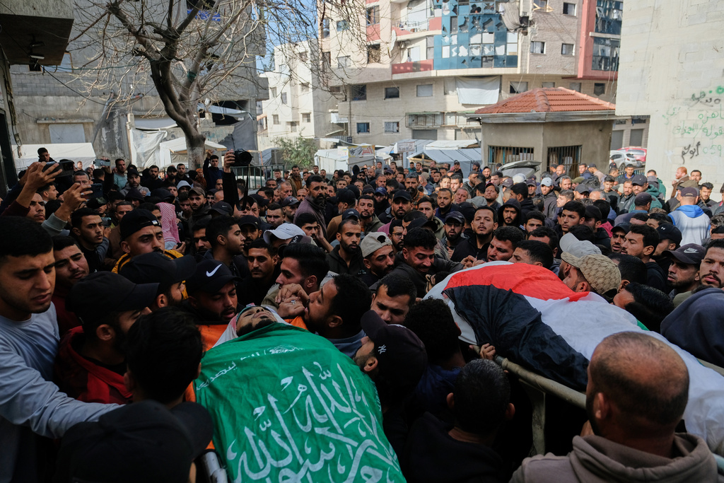 Palestinians carry the flag-draped bodies of two Hamas militants, Ahmed Sweilem, left, and Ibrahim Al-Za'anin, who were killed in an Israeli army strike, during their funeral in Gaza City, Tuesday, Feb. 10, 2026. (AP Photo/Jehad Alshrafi)