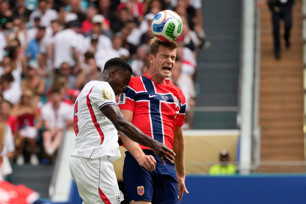 Norway's Alexander Soerloth, right, heads the ball challenged by England's Marc Guehi (6) during the World Cup quarterfinal soccer match between Norway and England in Miami Gardens, Fla., Saturday, July 11, 2026. (AP Photo/Chris Carlson)
