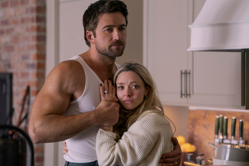 This image released by Lionsgate shows Brandon Sklenar, left, and Amanda Seyfried in a scene from "The Housemaid." (Lionsgate via AP)