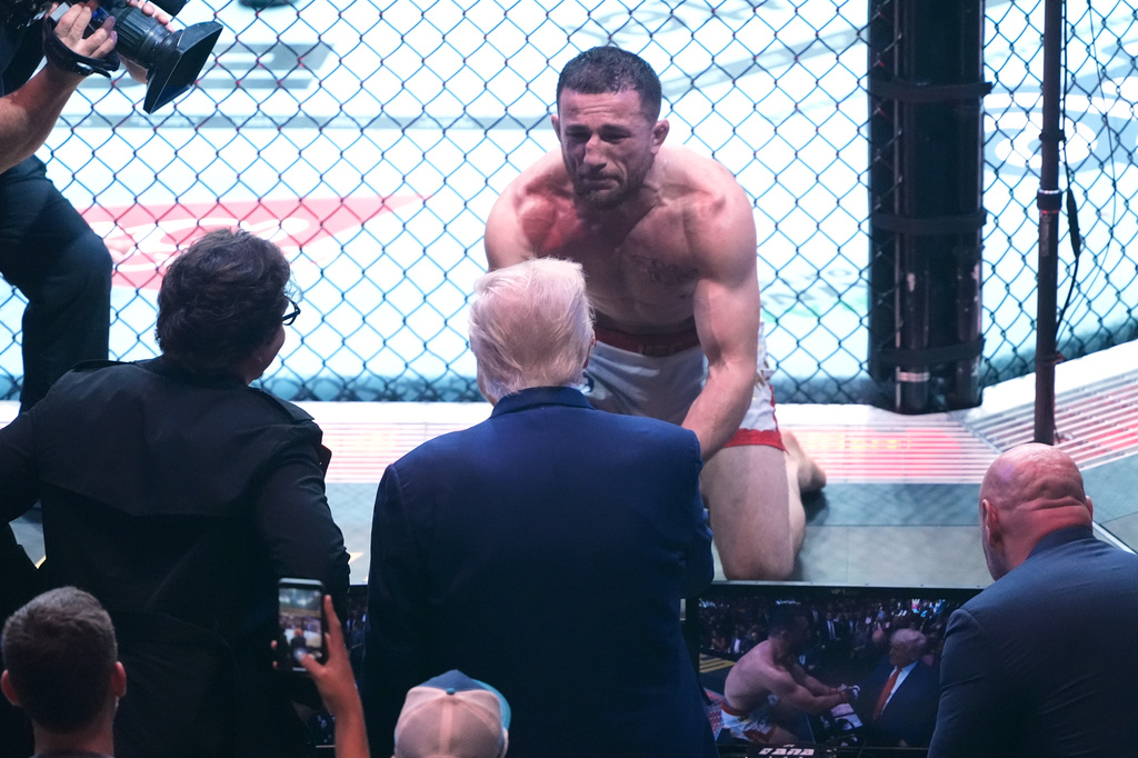 FILE - President Donald Trump congratulates Georgia's Merab Dvalishvili, after he won his bantamweight title bout against Sean O'Malley, during the UFC-316 mixed martial arts event, at the Prudential Center, June 7, 2025, in Newark, N.J. (AP Photo/Manuel Ceneta, File)
