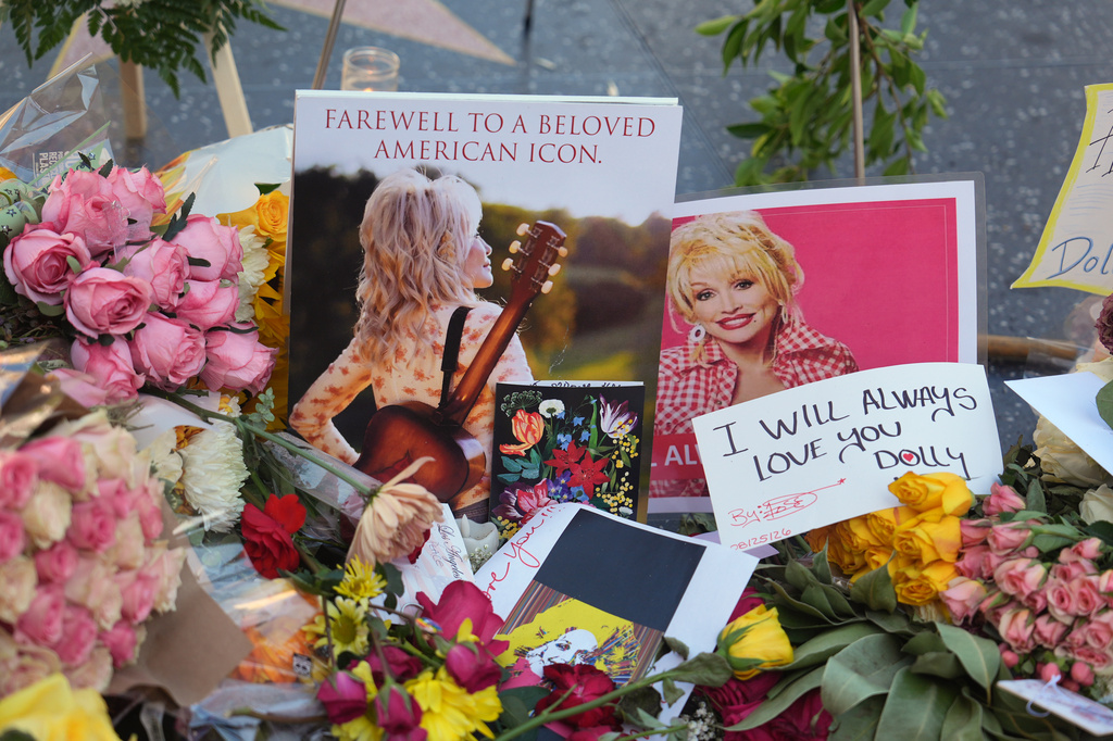 Flowers, notes and photos are left on Dolly Parton's star on the Hollywood Walk of Fame on Wednesday, Aug. 26, 2026, in Los Angeles. (AP Photo/Jae C. Hong)