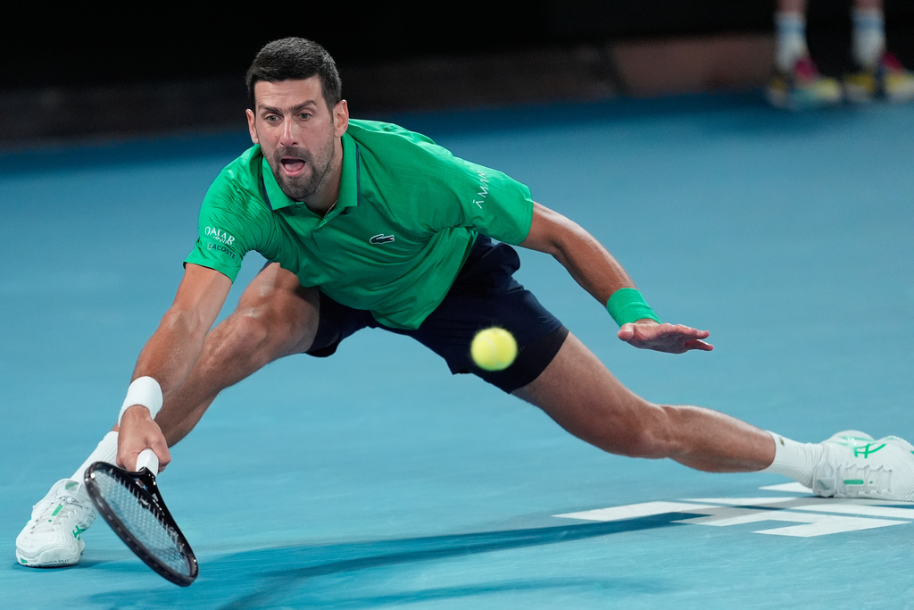 Novak Djokovic of Serbia hits a forehand to Carlos Alcaraz of Spain during the men's singles final at the Australian Open tennis championship in Melbourne, Australia, Sunday, Feb. 1, 2026. (AP Photo/Asanka Brendon Ratnayake)