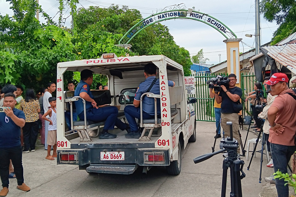 A police vehicle enters San Jose National High School a day after a shooting incident inside the school in Tacloban city, central Philippines, on Monday June 22, 2026. (AP Photo/Panfilo Vallejera)