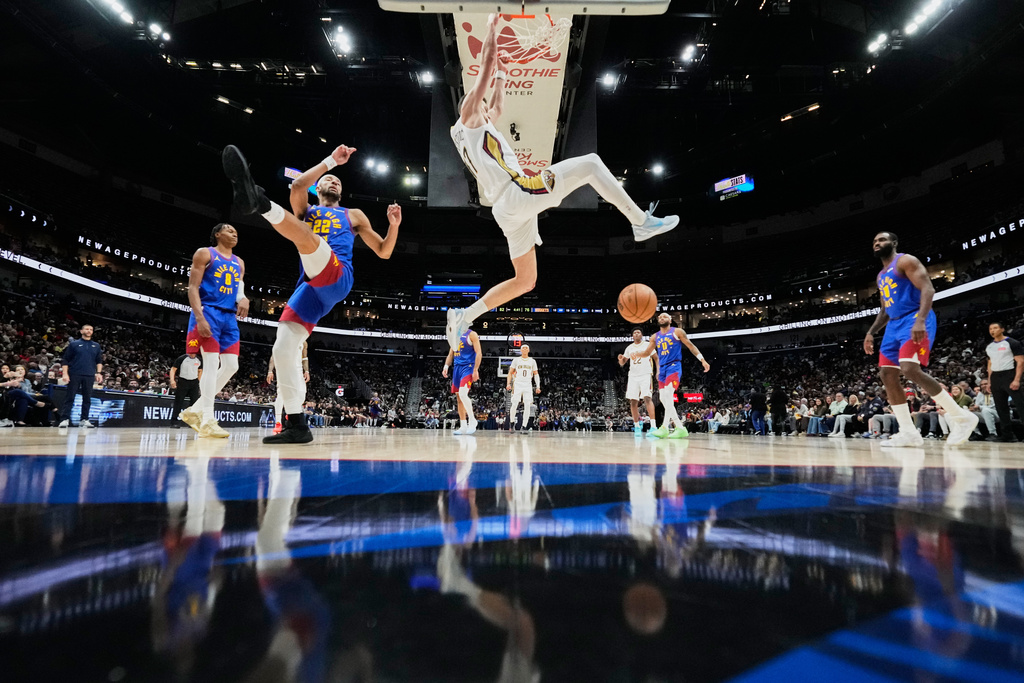 New Orleans Pelicans forward Karlo Matkovic slam dunk against Denver Nuggets forward Zeke Nnaji (22) in the second half of an NBA basketball game, Tuesday, Jan. 13, 2026, in New Orleans. (AP Photo/Gerald Herbert)