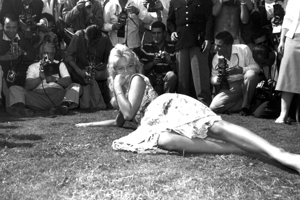 FILE - French actress Brigitte Bardot poses for photographers on a lawn in the garden of the Excelsior Hotel on the Lido of Venice, Italy, Sept. 2, 1958. (AP Photo/Walter Attenni, File)