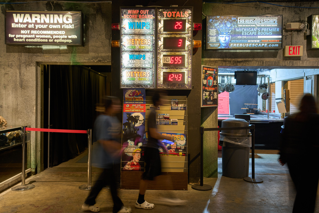 Visitors walk past an electronic "Wimp Board" at the Erebus Haunted House, Oct. 2, 2025, in Pontiac, Mich. (AP Photo/Ryan Sun)
