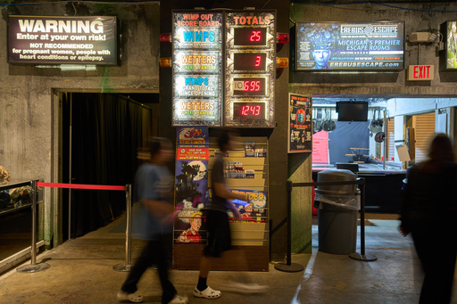 Visitors walk past an electronic "Wimp Board" at the Erebus Haunted House, Oct. 2, 2025, in Pontiac, Mich. (AP Photo/Ryan Sun) Visitors walk past an electronic "Wimp Board" at the Erebus Haunted House, Oct. 2, 2025, in Pontiac, Mich. (AP Photo/Ryan Sun)