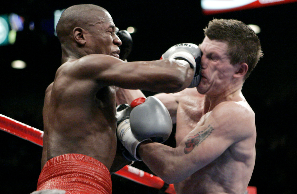 FILE - Floyd Mayweather Jr., left, punches Ricky Hatton, of Great Britain, during their WBC welterweight boxing title fight at the MGM Grand hotel-casino in Las Vegas, Saturday, Dec. 8, 2007. Mayweather won by 10th round knockout. (AP Photo/Jae C. Hong, File)