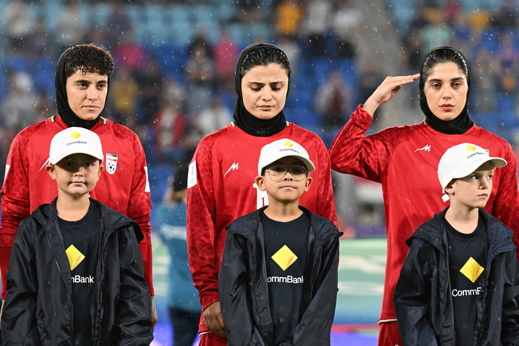 Iran players react during their national anthem ahead of the Women's Asian Cup soccer match between Iran and the Philippines in Robina, Australia, Sunday, March 8, 2026. (Dave Hunt/AAP Image via AP)