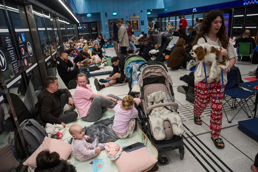 People take shelter in an underground metro station as air raid sirens warn of incoming strikes by Iran, in Ramat Gan, Israel, Saturday, Feb. 28, 2026. (AP Photo/Oded Balilty)