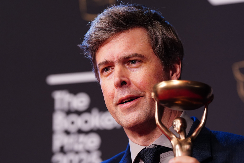 Author David Szalay poses for a photo after being named as the winner of the 2025 Booker Prize for the novel "Flesh," at Old Billingsgate, in London, Monday, Nov. 10, 2025. (Ian West/PA via AP)