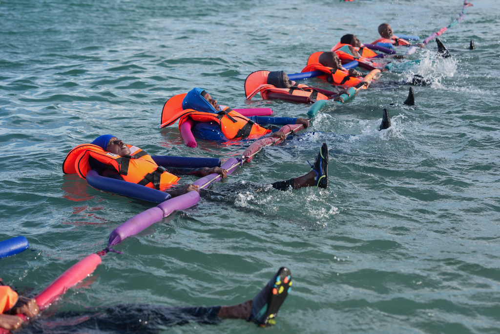 FILE - People with limited mobility issues receiving therapy in the ocean in Dakar, Senegal, Saturday, Dec. 13, 2025. (AP Photo/Misper Apawu, File)