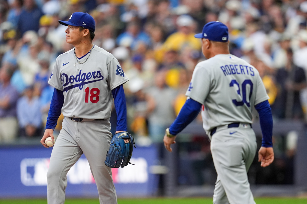 Los Angeles Dodgers manager Dave Roberts (30) pulls Los Angeles Dodgers pitcher Yoshinobu Yamamoto (18) from the game during the third inning of Game 2 of baseball's National League Championship Series between the Milwaukee Brewers and the Los Angeles Dodgers, Monday, Oct. 12, 2026, in Milwaukee. (AP Photo/Abbie Parr)