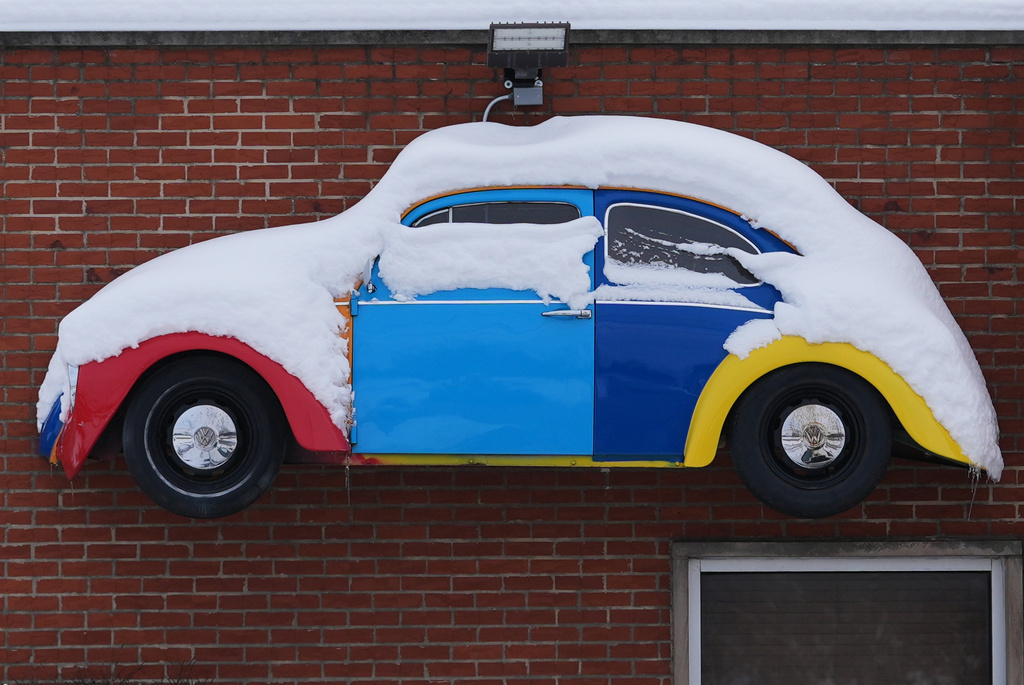 A snow-covered sign hangs on a shop in Northbrook, Ill., Tuesday, Dec. 2, 2025. (AP Photo/Nam Y. Huh)