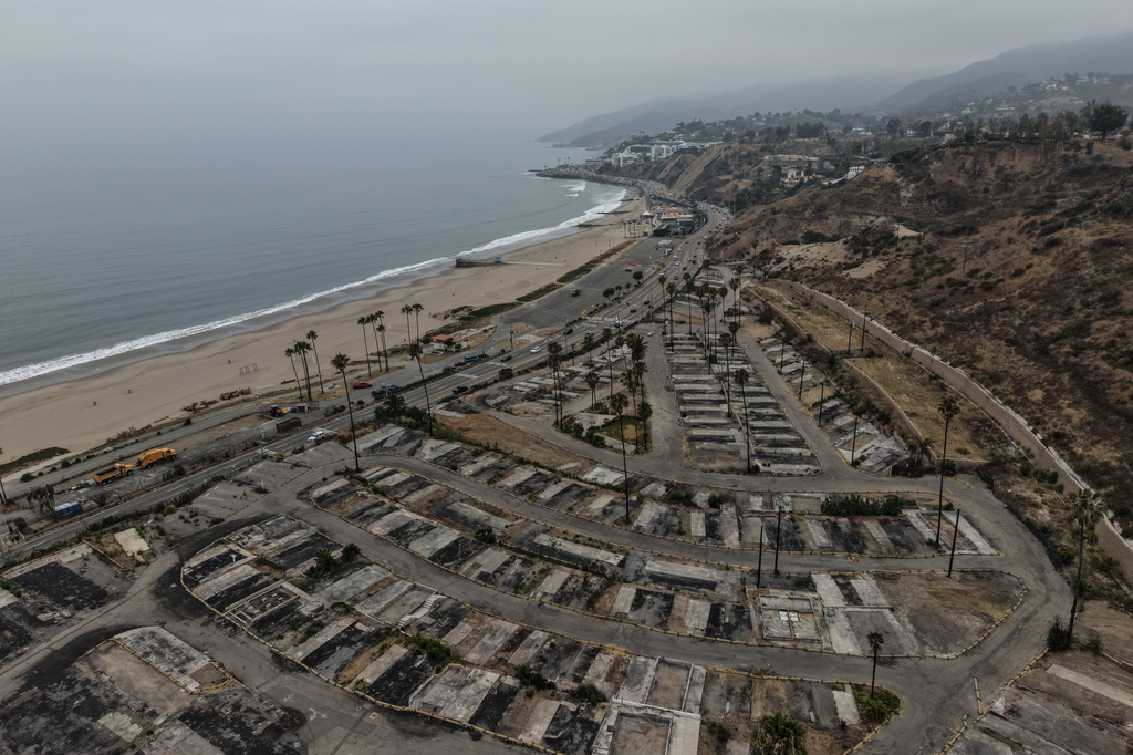 An aerial view shows the cleared site of a mobile home park more than a year after the Palisades Fire in the Pacific Palisades neighborhood of Los Angeles, Thursday, June 4, 2026. (AP Photo/Jae C. Hong)