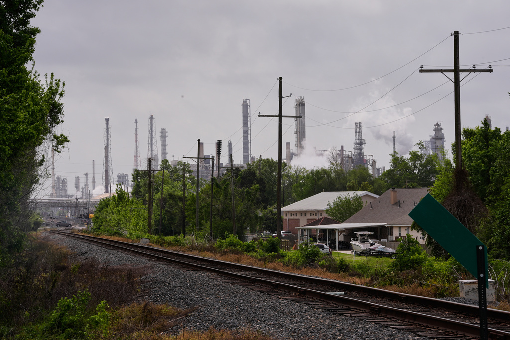 FILE - The Norco oil refinery is seen behind train tracks and residences in Norco, La., on April 2, 2026. (AP Photo/Gerald Herbert, File)