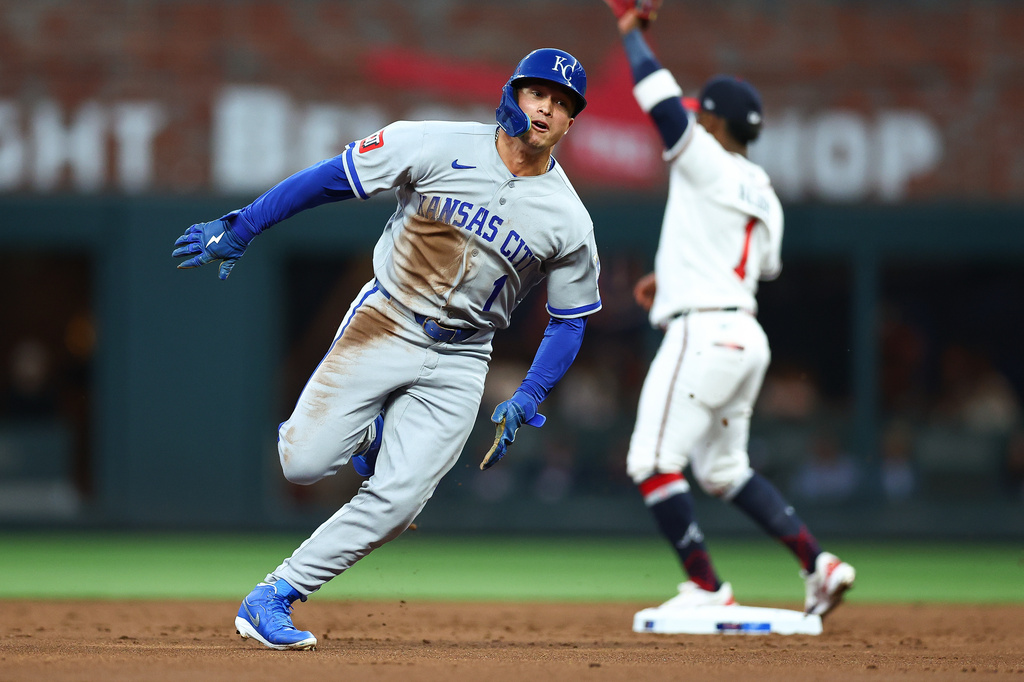 Kansas City Royals' Isaac Collins, left, rounds second base during the third inning of a baseball game against the Atlanta Braves, Saturday, March 28, 2026, in Atlanta. (AP Photo/Colin Hubbard)