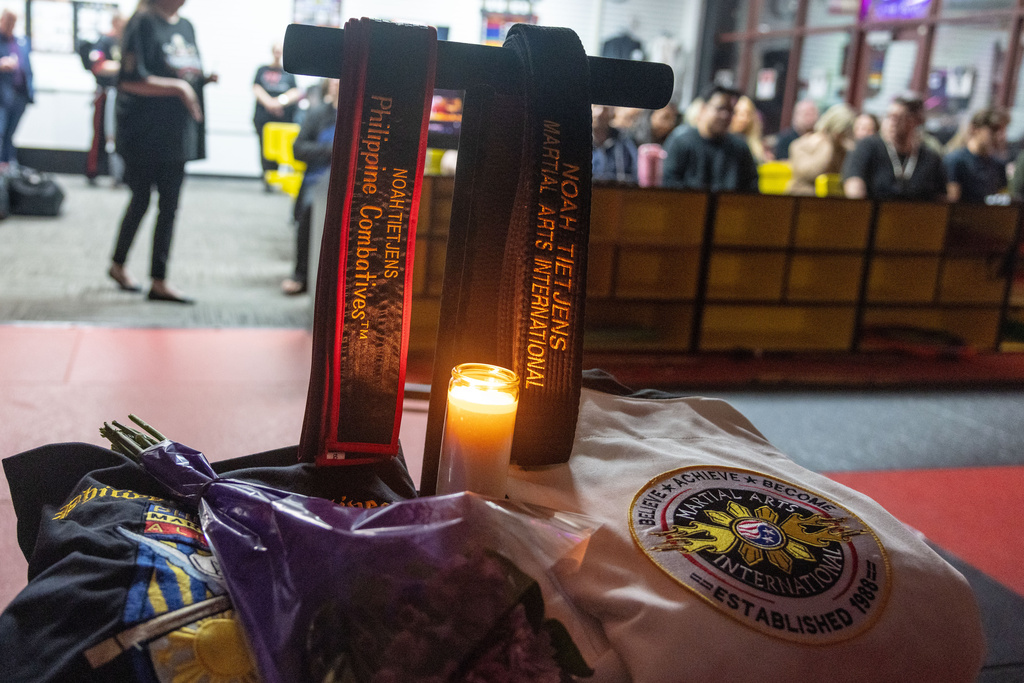 Candle burns during a candlelight mat ceremony for former student and instructor Noah Tietjens, who was killed in a drone strike at a command center in Kuwait, at Martial Arts International in Bellevue, Neb., Thursday, March 5, 2026. (Chris Machian/Omaha World-Herald via AP)