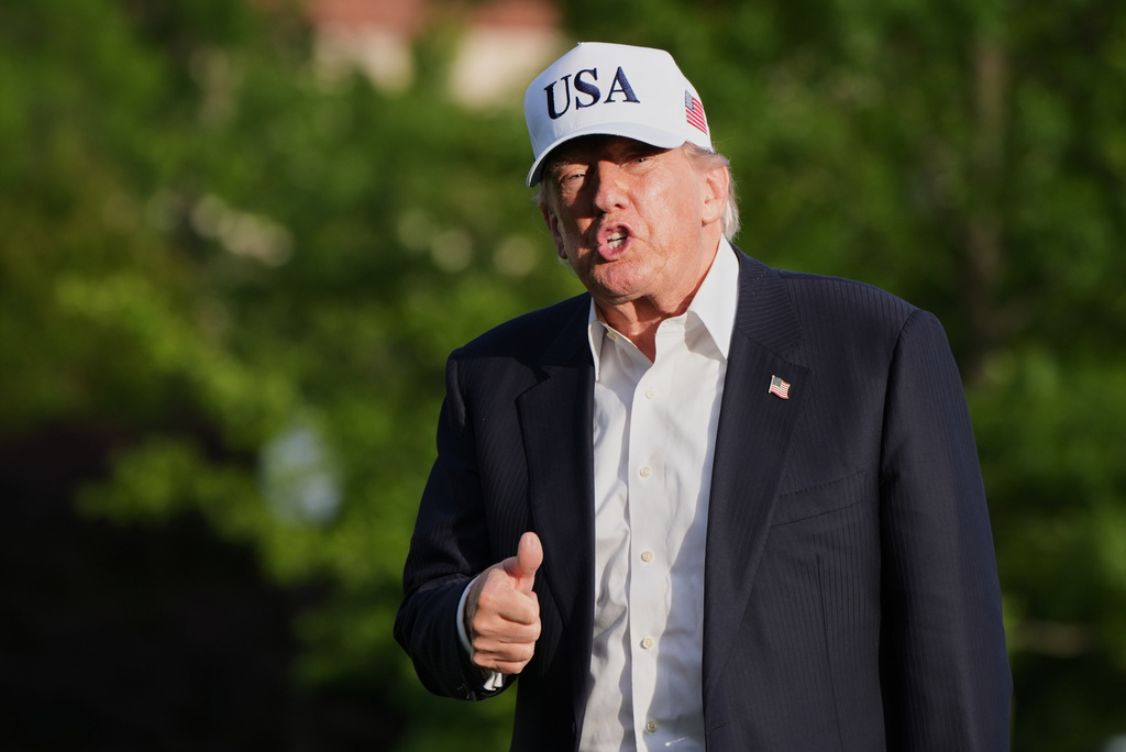 President Donald Trump gestures to reporters as he walks across the South Lawn of the White House, Friday, May 15, 2026, in Washington, on return from Beijing where he met with China's President Xi Jinping. (AP Photo/Jacquelyn Martin)