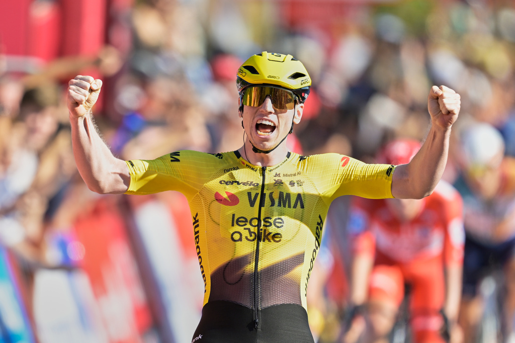 Britain's Matthew Brennan celebrates as he crosses the finish line to win the second stage of the La Vuelta cycling race, with start in Monaco and finish in Manosque, France, Sunday, Aug. 23, 2026. (AP Photo/Philippe Magoni)