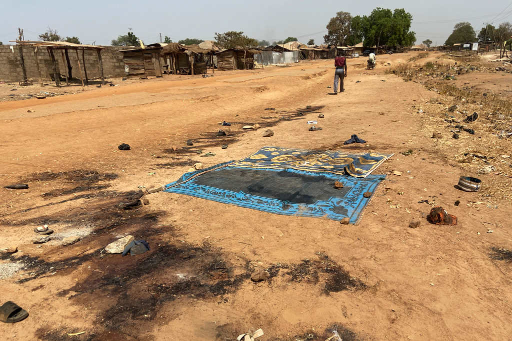 Blood stains cover the ground, days after an attack on the village of Woro, Nigeria, Thursday, Feb. 5, 2026. (AP Photo/ Musa Salim)