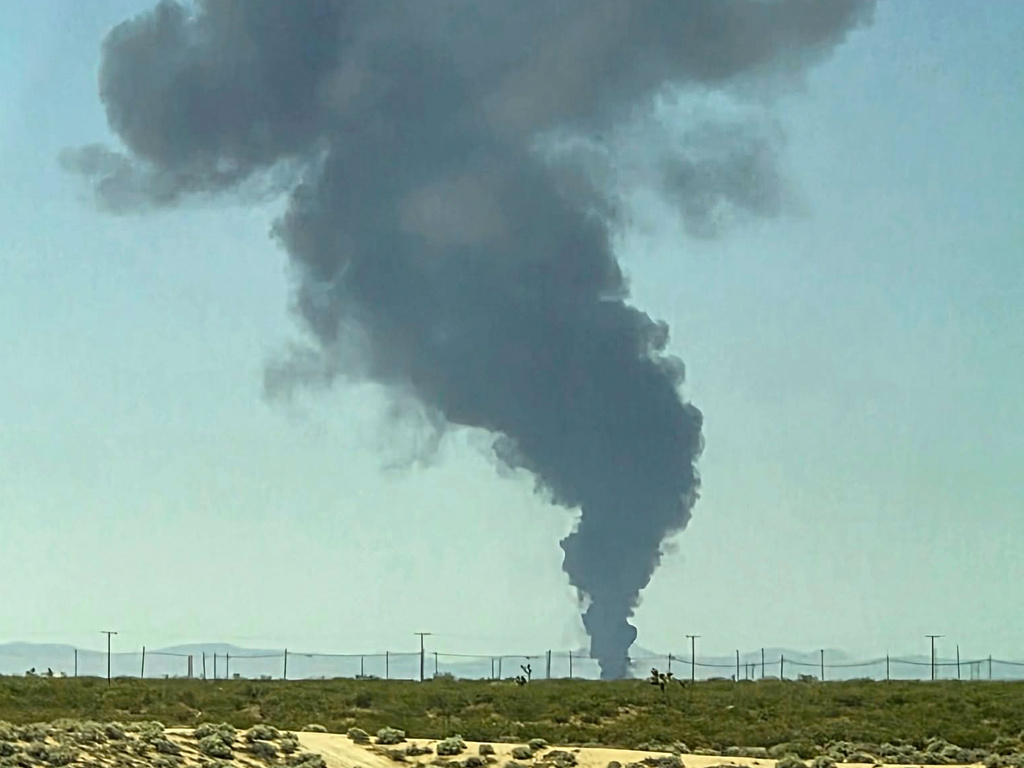 Smoke plumes rise from a B-52 bomber that crashed shortly after takeoff at a U.S. Air Force base in Southern California, Monday, June 15, 2026. (Debbie Reyes Katz via AP Photo)
