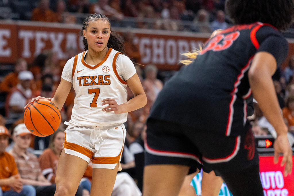 Texas guard Jordan Lee (7) looks past Georgia forward Mia Woolfolk (33) during the second half of an NCAA college basketball game Thursday, Feb. 26, 2026, in Austin, Texas. (AP Photo/Stephen Spillman)