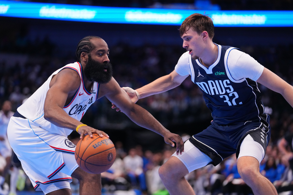 Los Angeles Clippers guard James Harden, left, works the floor against Dallas Mavericks forward Cooper Flagg during the second half of an NBA Cup basketball game Friday, Nov. 14, 2025, in Dallas. (AP Photo/Julio Cortez)
