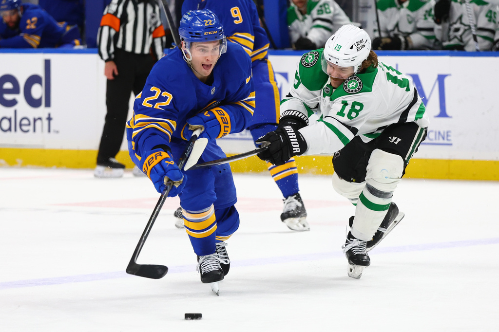 Buffalo Sabres right wing Jack Quinn (22) is pressured by Dallas Stars center Sam Steel (18) during the first period of an NHL hockey game Wednesday, April 15, 2026, in Buffalo, N.Y. (AP Photo/Jeffrey T. Barnes)