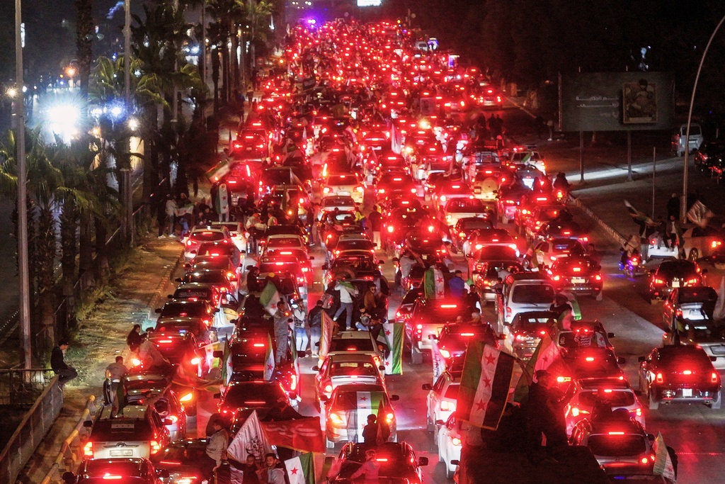 Syrians celebrate the first anniversary of the ousting of the Bashar Assad regime in Damascus, Syria, early Saturday, Dec. 6, 2025. (AP Photo/Ghaith Alsayed)