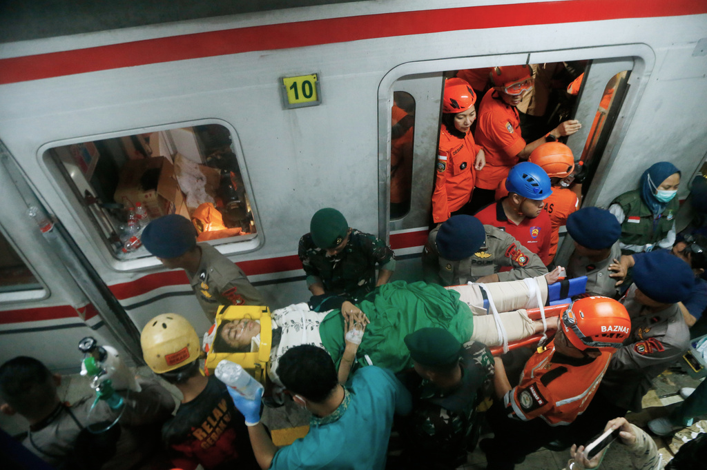 A passenger is being rescued after a train collision in Bekasi, Indonesia, Tuesday, April 28, 2026. (AP Photo)