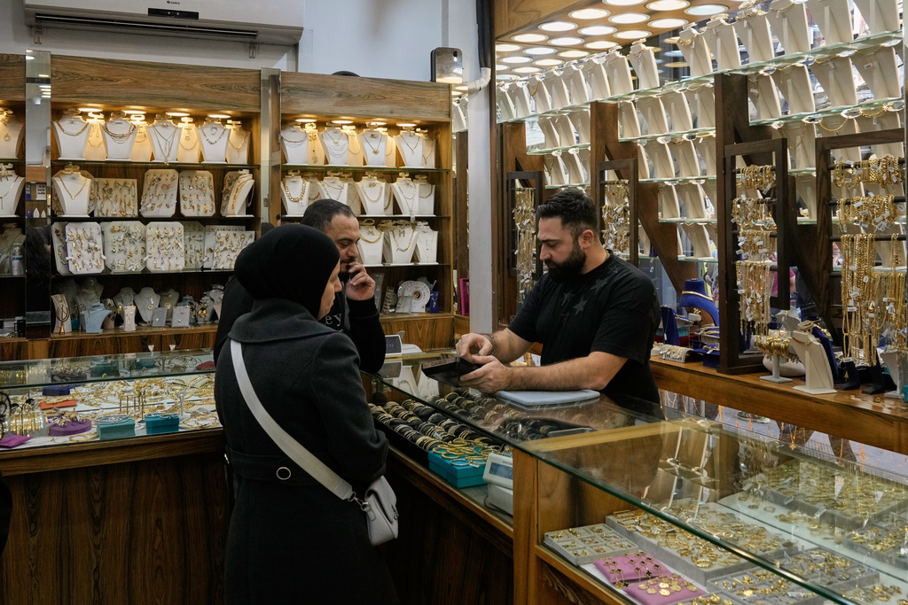A couple check out pieces of gold at a shop in Beirut, Lebanon, Monday, Feb. 2, 2026. (AP Photo/Bilal Hussein)