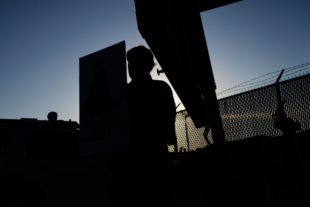 A protester holds a sign outside an ICE processing facility in the Chicago suburb of Broadview, Ill., Friday, Nov. 14, 2025. (AP Photo/Nam Y. Huh)