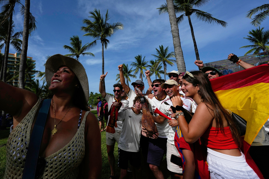 Spain fans celebrate their team's win over Belgium in their quarterfinal World Cup soccer match, at a public watch party in Miami Beach, Fla., Friday, July 10, 2026. (AP Photo/Rebecca Blackwell)